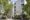 Exterior view of Cromwell Hospital in London, surrounded by lush green trees.